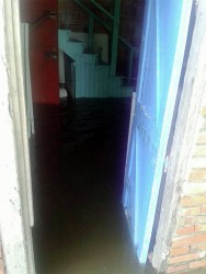 The flooded interior of a house at Land of Plenty