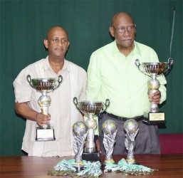 From left: Mark Archer and Pele President John Yates pose with the trophies yesterday. 