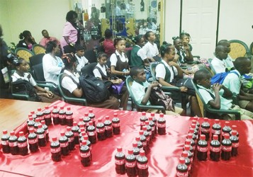 Attentive students listening to the officials during yesterday’s launch of the national “Skip Be Fit” competition, while bottles of Coca Cola spell out the word ‘SKIP’ in the foreground. 