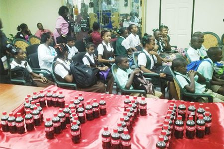 Attentive students listening to the officials during yesterday’s launch of the national “Skip Be Fit” competition, while bottles of Coca Cola spell out the word ‘SKIP’ in the foreground.