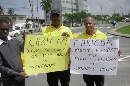 Protestors in front of the Caricom headquarters yesterday.