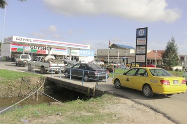 Vehicles drove up by the dozens for gas at the Diamond, East Bank GuyOil gas station yesterday afternoon. 