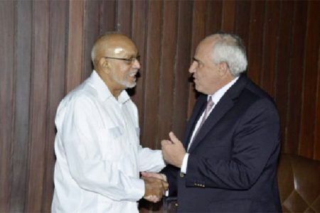 UNASUR Secretary General Ernesto Samper (right) greeting President Donald Ramotar at the Office of the President yesterday. (GINA photo)