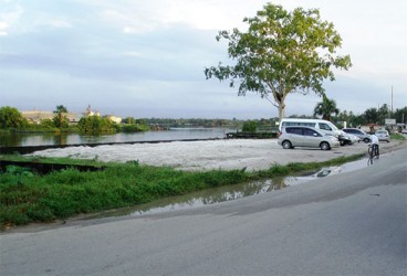 Looking south along Burnham Drive at the revetment on the west bank of the Demerara River, Wismar, Linden. 