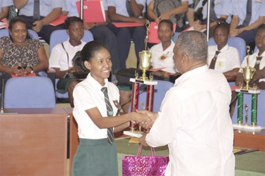 Lisa Sawh place first in the Caricom Energy Week Art Competition. Here she is receiving her trophy from Prime Minister Samuel Hinds. (Arian Browne photo)