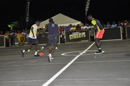 Darrel Alexis (far right) of DeKenderen about to challenge the opposing Vergenoegen All-Stars player (yellow) for possession of the ball during his side’s comfortable win
