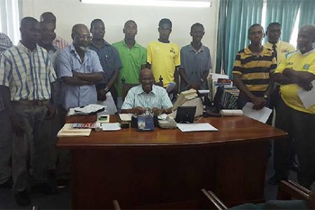 Mayor of Georgetown Hamilton Greene (sitting) and tournament coordinator Lennox Arthur (fourth from right) flanked by members of the participating clubs during the official launch of the 21st edition of the Mayor’s Cup Knockout Tourney

