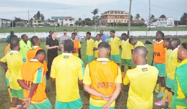 GFF Technical Director Claude Bolton addressing the Golden Jaguars senior side prior to the commencement of their final local training session at the Guyana Defence Force ground