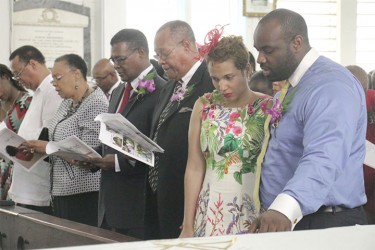The late Dr Faith Harding’s husband, Patrick Harding, fourth from right, daughter-in-law Lisa, second from right, and son Patrick Jnr, at right, sing a hymn at her funeral service at Christ Church yesterday. See story on page 2. (Photo by Arian Browne) 