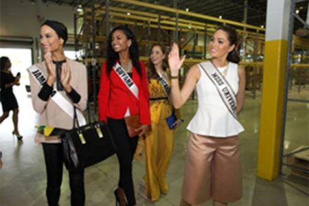 Reigning Miss Universe Gabriela Isler of Venezuela, on far right, tours Food For The Poor's warehouse with Miss Universe contestants (from left) Miss Jamaica Kaci Fennell, Miss Guyana Niketa Barker and Miss Nicaragua Marline Barberena.