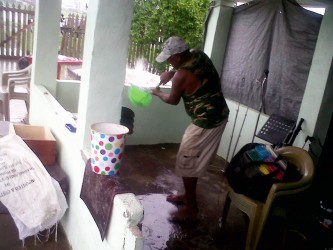 This man was trying to bail water out of his flooded downstairs apartment in Richmond.