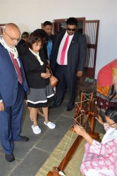 President Donald Ramotar (left), First Lady Deolatchmee Ramotar (second from left), BK Group of Companies CEO Brian Tiwari and Housing Minister Irfaan Ali (right) looking at the method used by the late Mahatma Gandhi to make his own clothes, during a tour of the Gandhi museum in Ahmedabad. (GINA photo)