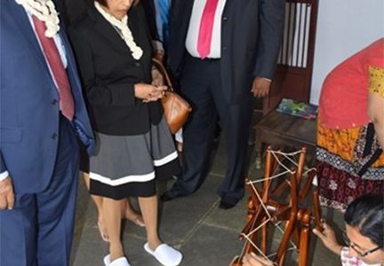 President Donald Ramotar (left), First Lady Deolatchmee Ramotar (second from left), BK Group of Companies CEO Brian Tiwari and Housing Minister Irfaan Ali (right) looking at the method used by the late Mahatma Gandhi to make his own clothes, during a tour of the Gandhi museum in Ahmedabad. (GINA photo)