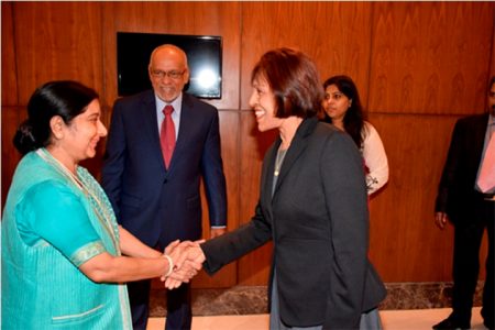 First Lady Deolatchmee Ramotar (right) is greeted by Minister of External Affairs and Overseas Indian Affairs, Sushma Swaraj.  President Donald Ramotar looks on. Ramotar is on a state visit to India. (GINA photo)