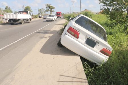 This driver ended up off-road at Farm, East Bank Demerara after a bit of reckless driving. (Photo by Arian Browne)