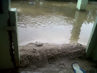 Sand placed at a door to prevent the floodwater from entering this house at Richmond.