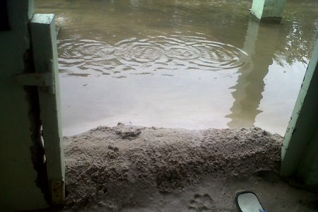 Sand placed at a door to prevent the floodwater from entering this house at Richmond.