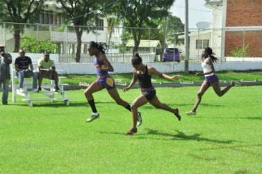 Natrena Hooper dips to win the 80m open event. (Orlando Charles photo)