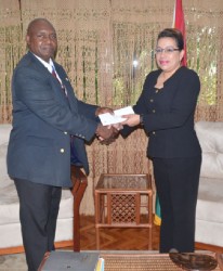 Reuben Hamilton Robertson presenting his credentials to Foreign Affairs Minister Carolyn Rodrigues-Birkett yesterday.