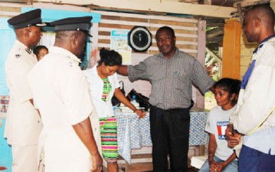 Commander of ‘D’ Division, Marlon Chapman (second from right) with senior officer, Clayburn Johnson and the pastors consoling Subrina and her mother (sitting)