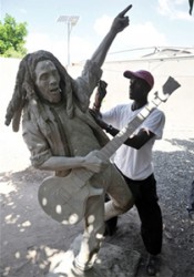 Osmond Watson sanding down the new, unfinished life-size statue of the late reggae super star Bob Marley at the Trench Town Culture Yard in Kingston on Thursday. Sculpted by Scheed Cole, the completed statue will be unveiled tomorrow. Cole was commissioned to do the statue in late December last year to replace the old one. 