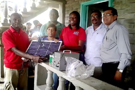 (From right to left) Region Six Vice-Chair-man Bhopaul Jagroo, Regional Chairman David Armogan, Food for the Poor project coordinator Andrea Benjamin, President of St Francis Community Developers Alex Foster and residents during the distribution.