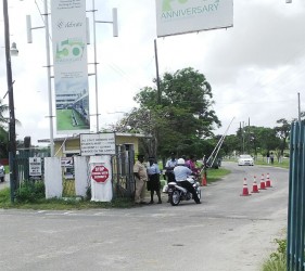 Police ranks at the main entrance of the University of Guyana yesterday morning. 