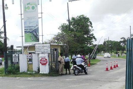 Police ranks at the main entrance of the University of Guyana yesterday morning.
