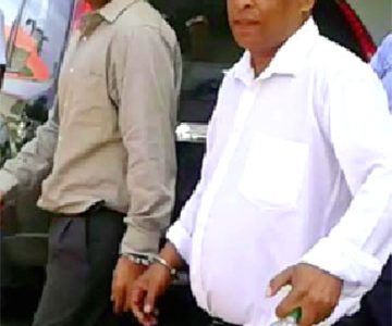 The two accused being escorted from court. From right are Dharmraj Persaud, 41, and Yougeshwar Dhanaram, 32.
