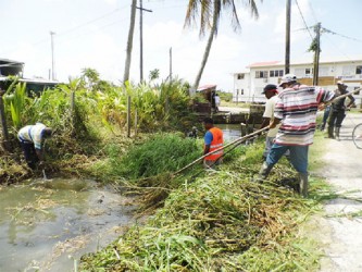 NDC workers de-silting a drain through Lord Street 