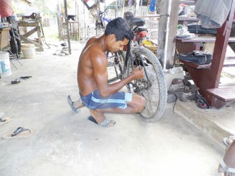 Attempting to straighten a spoke on the bicycle