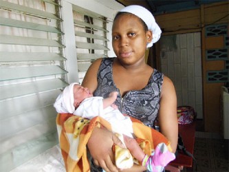19-year-old Abigail holding her new born baby - the newest addition to the village