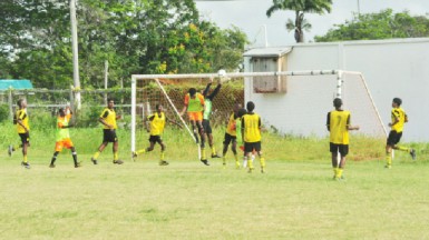 St. George’s High’s Adolph George (centre) attempting to latch onto a right sided cross while being challenged by the Brickdam Secondary goalkeeper during his side’s comprehensive victory.   