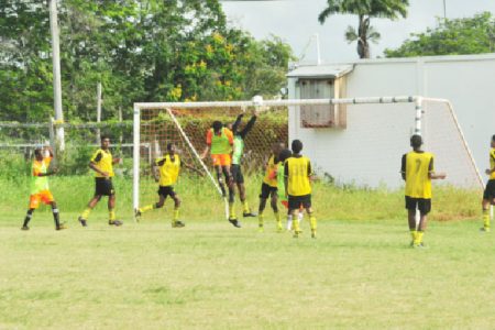 St. George’s High’s Adolph George (centre) attempting to latch onto a right sided cross while being challenged by the Brickdam Secondary goalkeeper during his side’s comprehensive victory.
