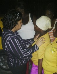 Education Minister Priya Mancikchand consoling Roberta Abel outside the Mahaicony Cottage Hospital  last night.