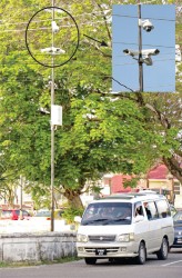 Big brother is watching: Police are now using the CCTV cameras, like the kind pictured here at the junction of Camp and Lamaha streets, to prosecute errant drivers. (Phtotos by Arian Browne)