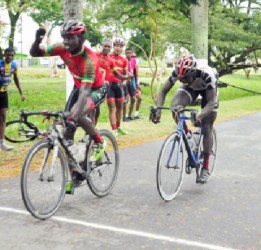 Team Coco’s Hamza Eastman reacts after crossing the finish line ahead of Team Evolution’s Orville Hinds and Alonzo Ambrose. (Orlando Charles photo) 