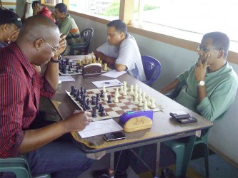 Loris Nathoo (right) faces Frankie Farley in a National Chess Championship. Nathoo has quietly suggested that the format of the existing championship be slightly modified to create and sustain awareness.  