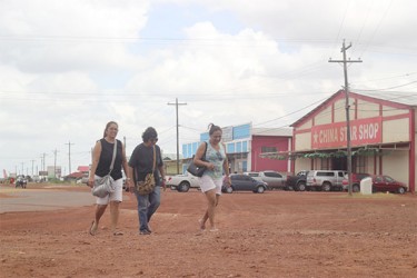 Brazilian shoppers walk in the Lethem Commercial Zone