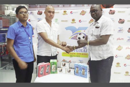 Kashif and Shanghai Co-Director Aubrey Major (right) collecting the sponsorship cheque from Managing Director of Cellphone Shack Chris Low-Koan (centre) while Plum Brand Representative Plum Representative Pream Sundarsan(left/blue) look on