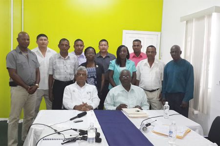 GECOM’s Chairman, Dr Steve Surujbally (seated at left) and Chief Election Officer, Keith Lowenfield (seated) with the 10 Returning Officers. 