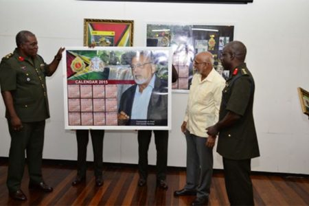 Chief  of  Staff Brigadier Colonel Mark Phillips (left) and Commander-in-Chief, President Donald Ramotar (second from right) unveiling the Guyana Defence Force’s 50th Anniversary Calendar yesterday. (GINA photo)