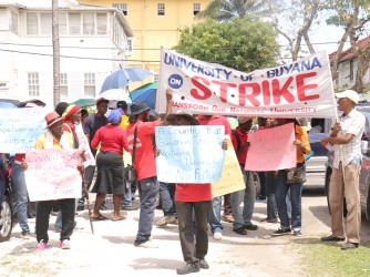 Picketers outside of the Ministry of Labour on Brickdam yesterday during the march to Georgetown.