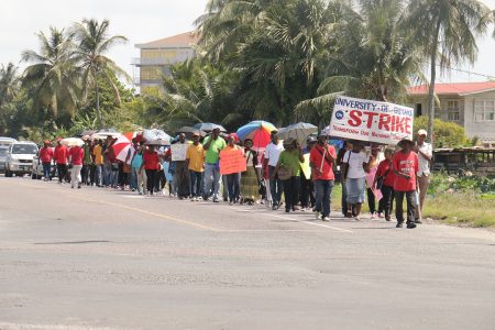 University of Guyana staff and others marching along the East Coast Demerara Railway Embankment on their way to Georgetown to protest over wages and other matters.