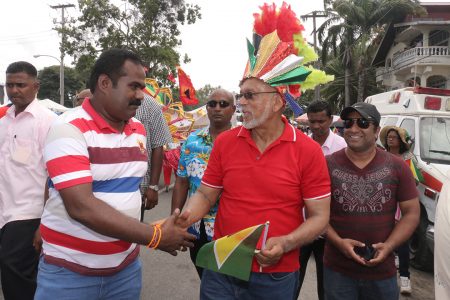 President Donald Ramotar (centre) being greeted as he mashed in the PPP’s PYO Float.