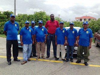 President of the United Minibus Union Eon Andrews (fourth, right) poses with the Tuschen Hire Car Service (THCS) drivers, who have kicked their service up a notch by being properly attired and easily identifiable. (Photo by Shabna Ullah)   