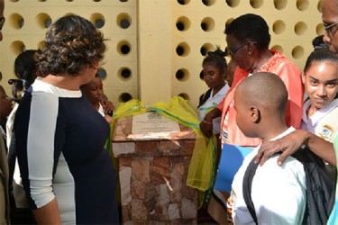 Minister of Education, Priya Manickchand (left) along with students during the unveiling of the plaque to commission the elevation of the North Ruimveldt Secondary School. (GINA photo) 