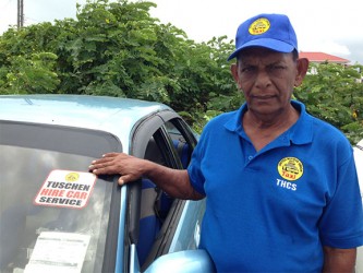 President of the THCS, Sheik Mohamed points to the sticker on his car