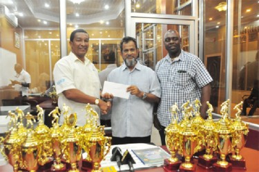 Kashif and Shanghai Co-Director Kashif Mohammed (left) collecting the first place cheque from Mohamed’s Enterprise Proprietor Nazar Mohamed (centre) while Aubrey Major looks on. 