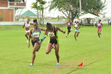 Kenisha Williams, wins the girls U-18 100 metres yesterday in a driving finish. (Orlando Charles photo) 